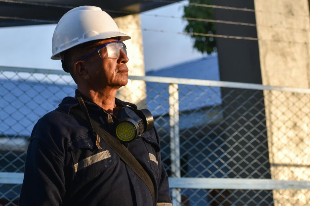 Trabalhador industrial idoso usando capacete e óculos de proteção em Santo André, simbolizando o segurado com visão monocular que busca a revisão da aposentadoria PcD